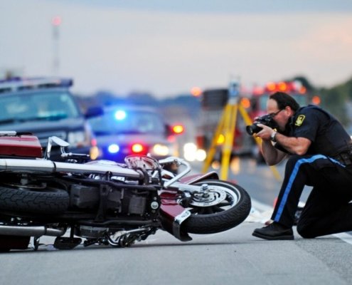 Motorcycle accident scene on a Salt Lake City street with emergency responders