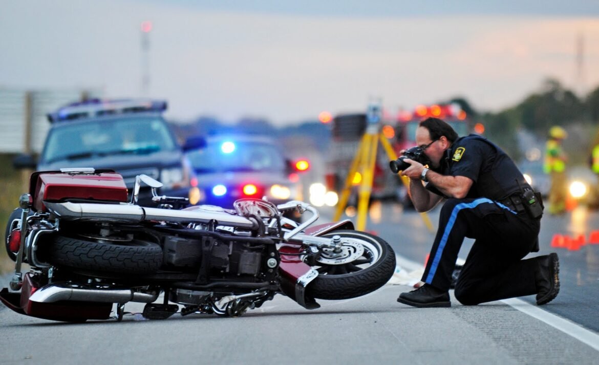 Motorcycle accident scene on a Salt Lake City street with emergency responders